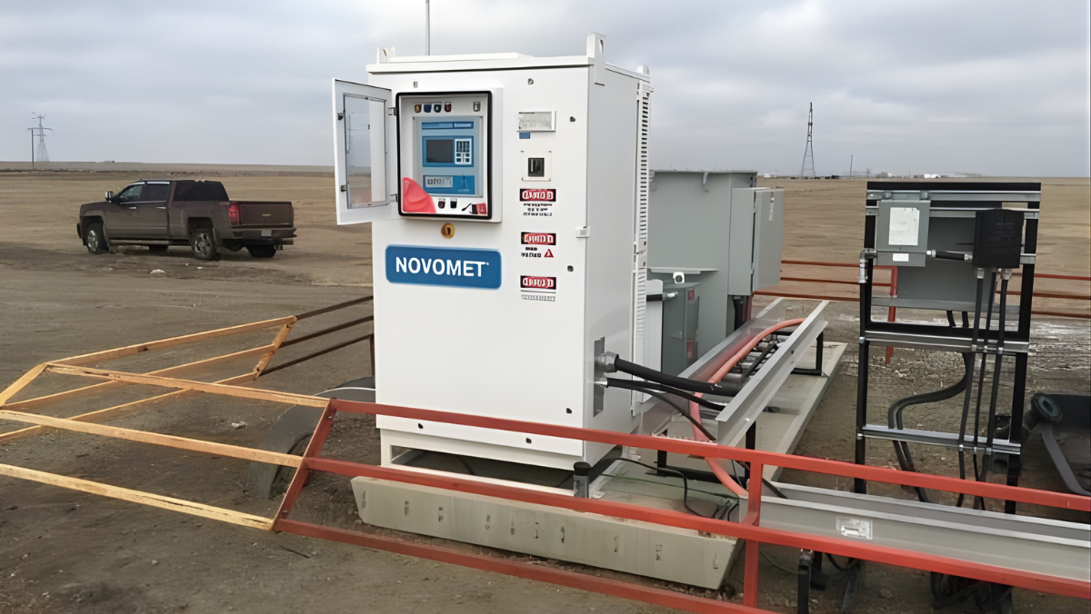 Compact Novomet control unit installed on remote well pad with cables connected.