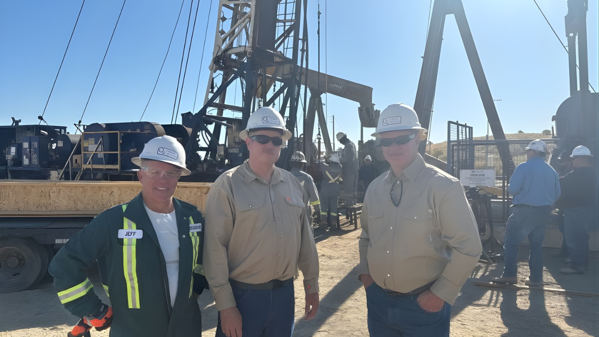 Oilfield technicians inspecting artificial lift infrastructure at a North American well site