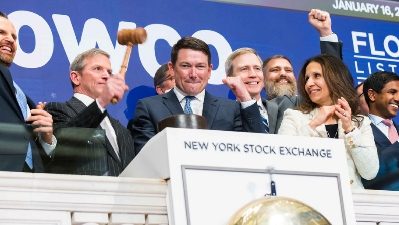 Executives at New York Stock Exchange podium during bell ceremony