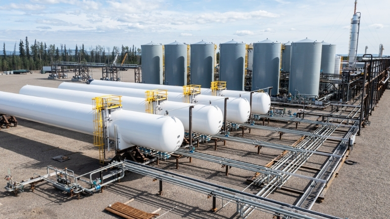Oil and gas processing site with storage tanks and pipeline systems